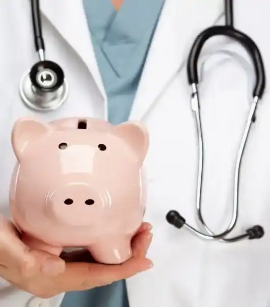a doctor holding a piggy bank