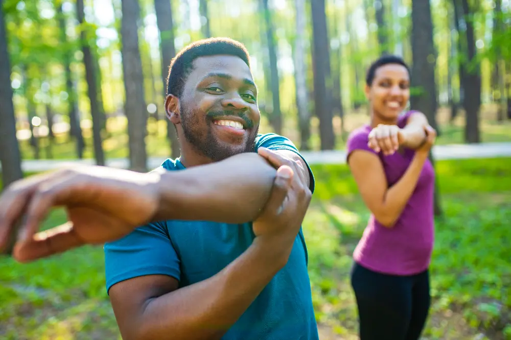 young man and beautiful woman doing stretching exercises
